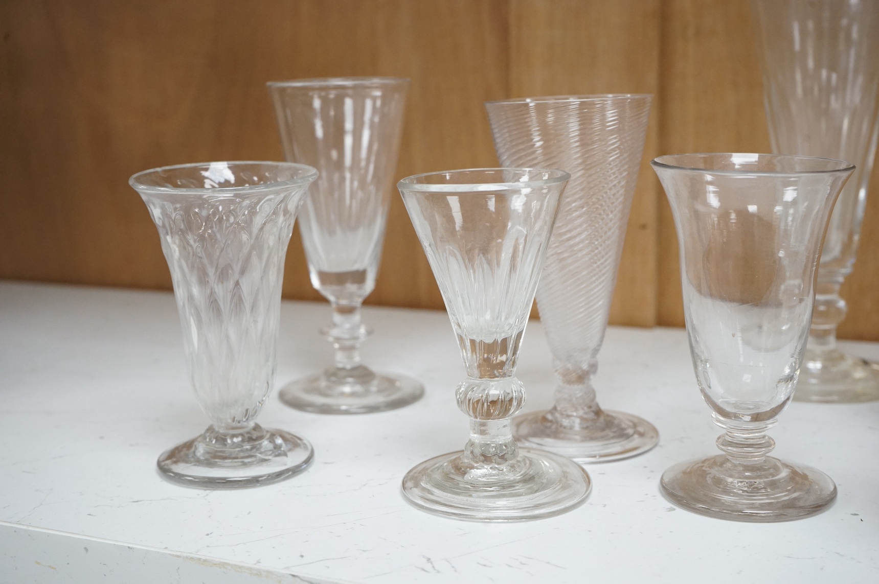 Ten 18th century and later drinking glasses, some with wrythen stems, largest 18cm high. Condition - mostly fair/good